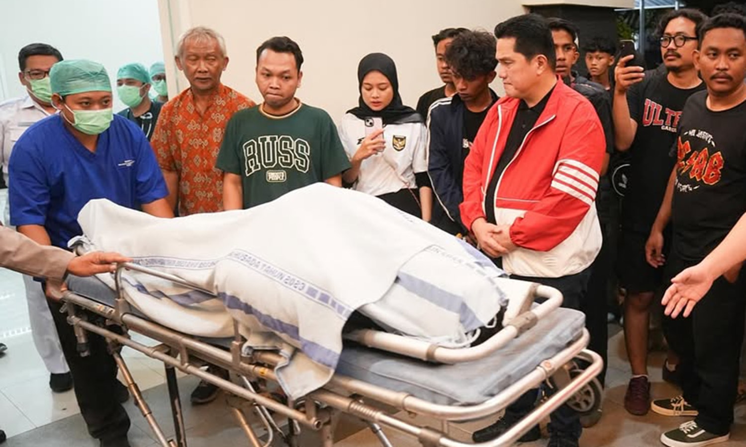 Chủ tịch LĐBĐ Indonesia Erick Thohir bên thi thể cổ động viên xấu số.