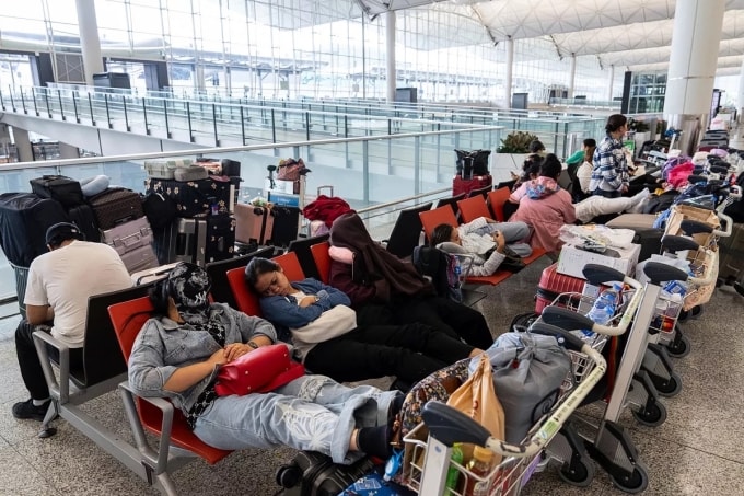 Hành khách nghỉ tạm tại Sân bay Quốc tế Hong Kong trước khi siêu bão Ragasa đổ bộ, ngày 23/9. Ảnh AP/Chan Long Hei