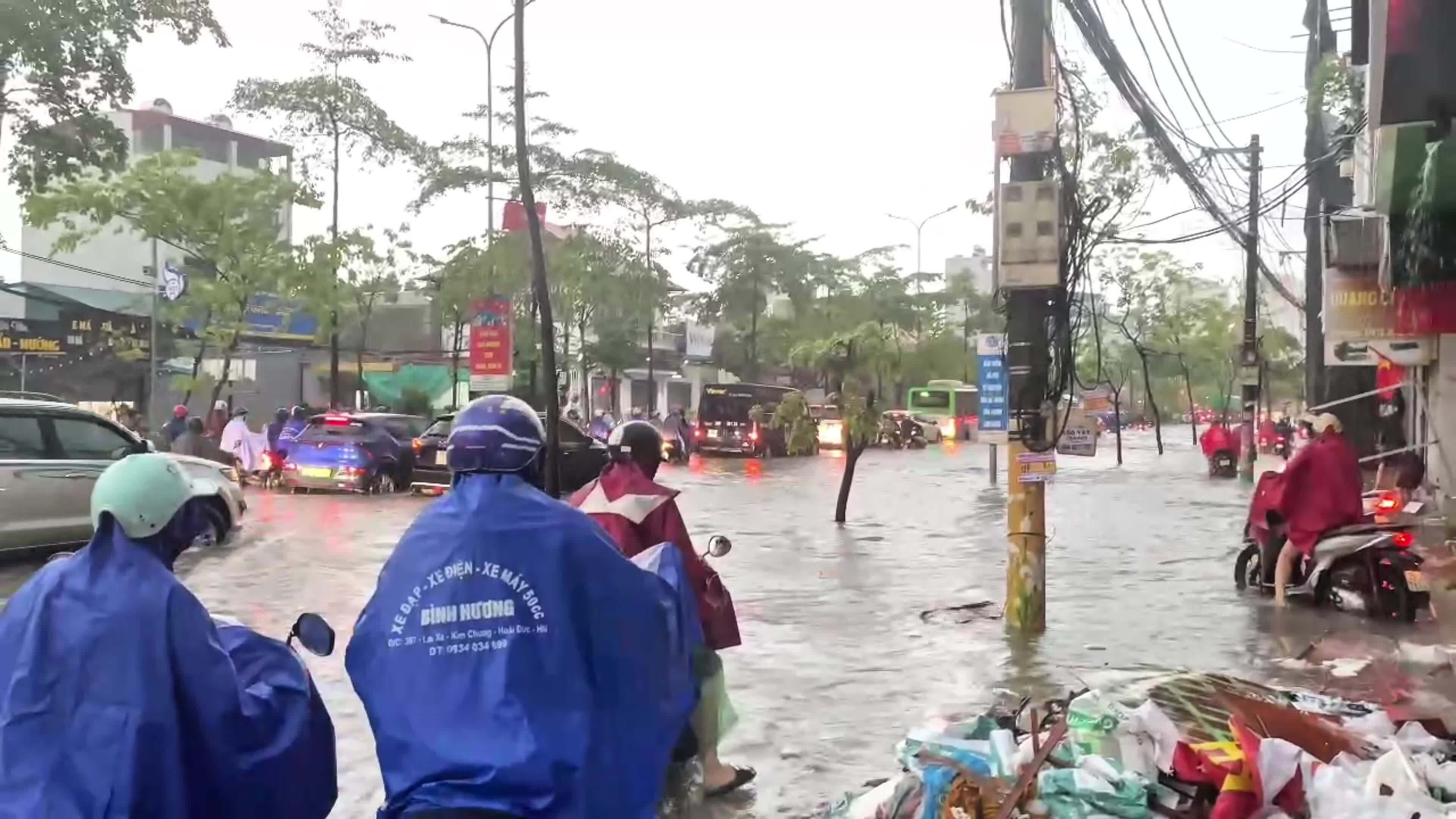 Người Hà Nội vật lộn đưa con đi học, đi làm trong mưa lớn
