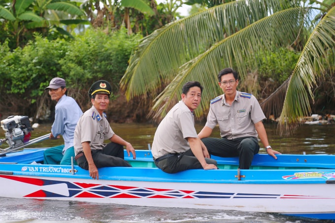 Chấp hành viên thi hành án dân sự tỉnh Kiên Giang (cũ) đi thuyền đến nơi tống đạt. Ảnh: Phạm Dự