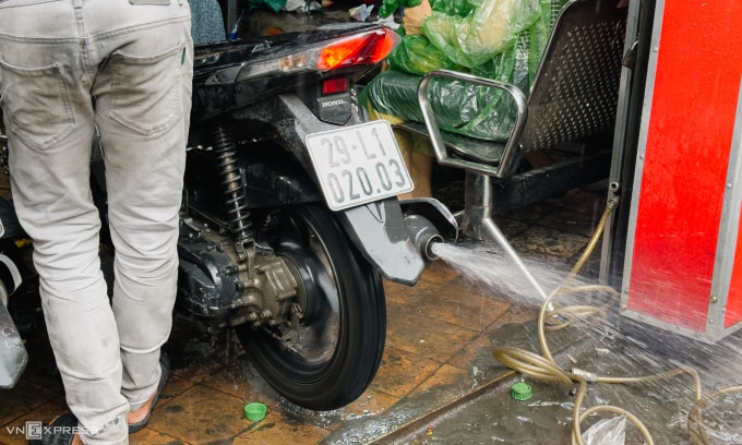 Nước bắn ra từ ống xả của xe tay ga sau khi lội nước. Ảnh: Minh Quân