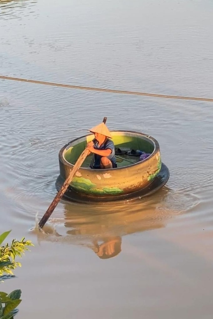 Bố Tuấn dùng chén trà làm thuyền lấy đồ cứu trợ. Ảnh: NVCC