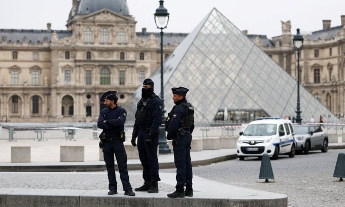 Cảnh sát đứng gác bên ngoài bảo tàng Louvre ở Paris hôm 19/10, sau khi vụ cướp xảy ra. Ảnh: Reuters