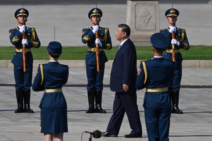 Chinas President Xi Jinping (3rd R) walks to the Monument to the Peoples Heroes during a wreath laying ceremony to honour deceased national heroes on Martyrs Day in Beijings Tiananmen Square on September 30, 2025. (Photo by GREG BAKER / AFP)