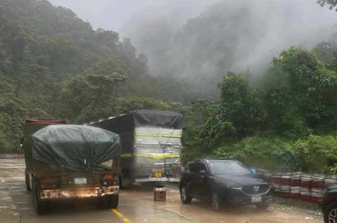 Nhiều ô tô tải và cả xe cá nhân tìm cách di chuyển trên đèo Lò Xo qua các khu vực không có sạt lở. Ảnh: Minh Tuân