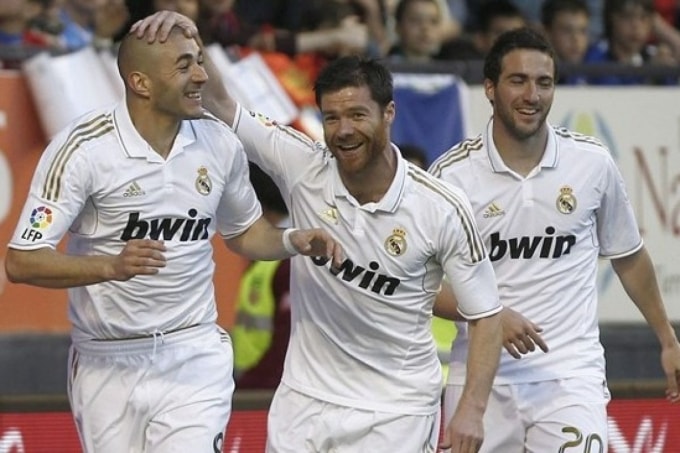 Benzema (trái) chia vui với Xabi Alonso (giữa) thời cả hai còn là đồng đội ở Real Madrid. Ảnh: AFP