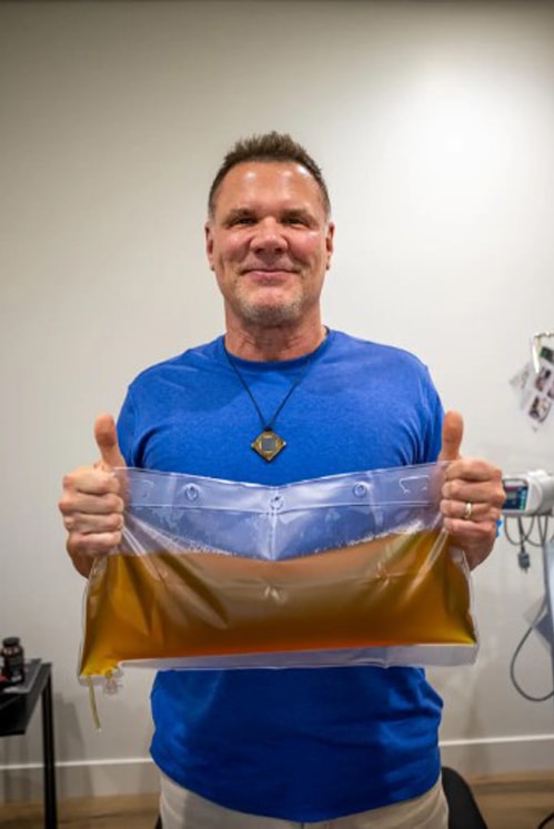 Van Es khoe phần huyết tương cũ, được rút ra khỏi cơ thể ông sau gần ba giờ. Ảnh: NY Post