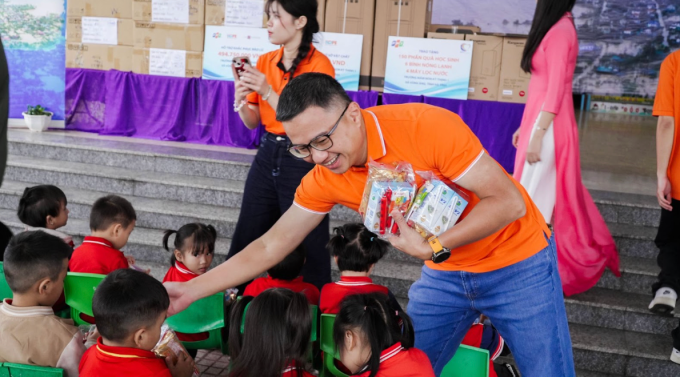 Đại diện Tập đoàn FPT tặng quà cho các em học sinh tại điểm Đông Phong, trường Mầm non Kỳ Thịnh. Ảnh: Ngân Trần