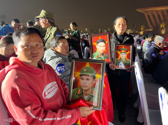 Thân nhân liệt sĩ mở di ảnh gặp lại người thân, tối 12/12. Ảnh: Hoàng Phương
