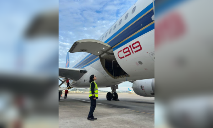 Cơ trưởng Yu Yue bên cạnh máy bay C919. Ảnh: GMW