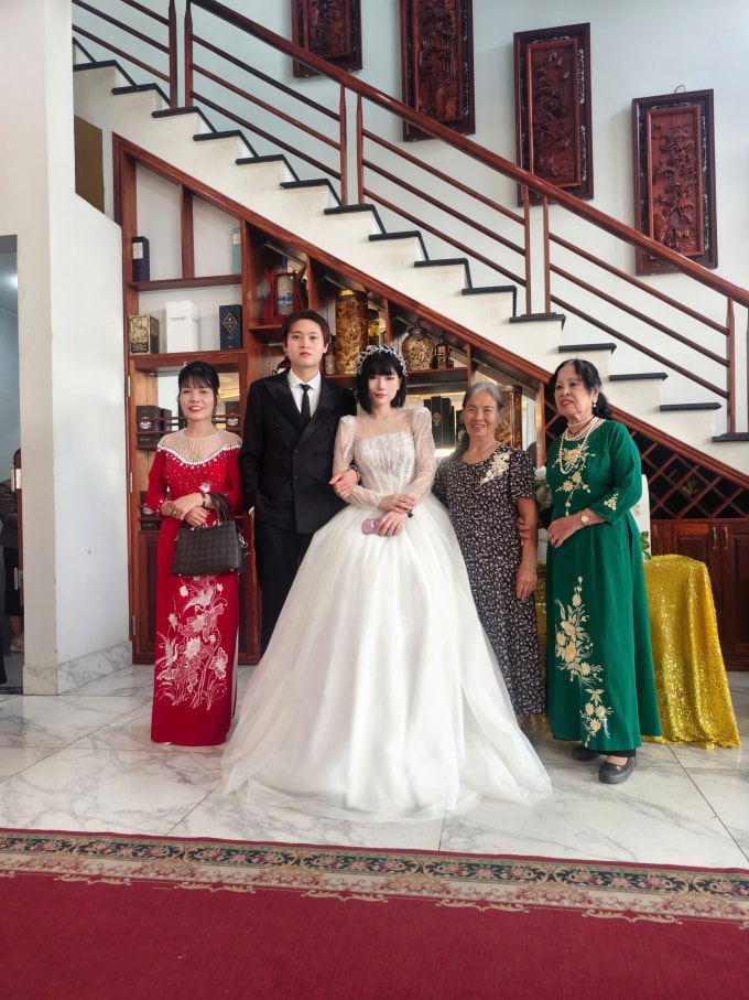 Vợ chồng Dương và Saika chụp ảnh lưu niệm cùng người thân trong lễ cưới tháng 12/2025. Ảnh nhân vật cung cấp