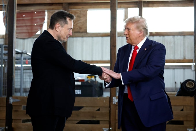 Donald Trump (phải) bắt tay với Elon Musk trong một sự kiện vận động tranh cử ở Butler, Pennsylvania, hồi tháng 10/2024. Ảnh: AFP
