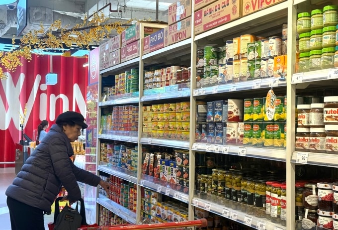 Một người dân tìm mua các sản phẩm đóng hộp ăn liền tại siêu thị trên đường Trần Đăng Ninh, Hà Nội chiều 8/1. Ảnh: Quỳnh Nguyễn