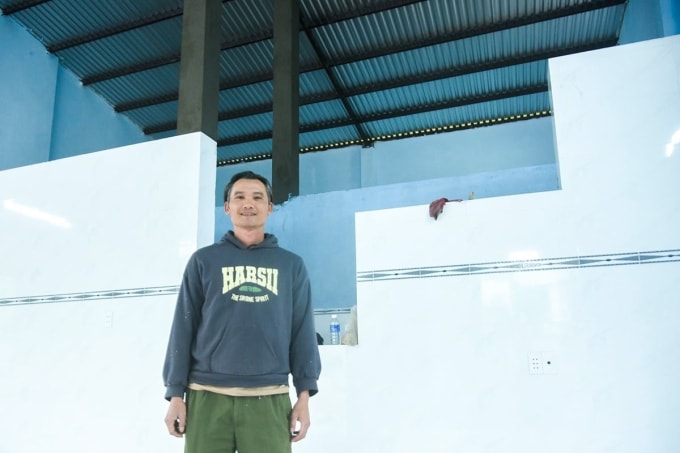 Anh Nguyễn Định, ở thôn Đồng Chàm, xã Thượng Đức, TP Đà Nẵng, vui mừng trong căn nhà mới được các chiến sĩ công an dựng lại sau lũ. Ảnh: Ngọc Trường