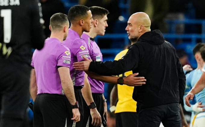 HLV Pep Guardiola chất vấn trọng tài Farai Hallam sau trận. Ảnh: PA