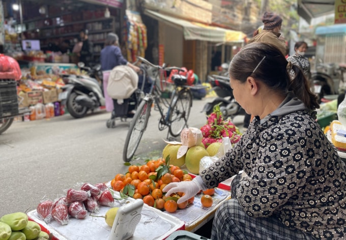 Bùi Thị Trà, 58 tuổi bán hoa quả tại chợ cóc gần chợ Mơ, sáng 12/1. Ảnh: Phan Dương