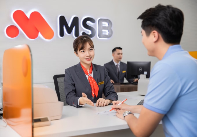 Khách hàng làm thủ tục gửi tiền tại quầy. Ảnh: MSB