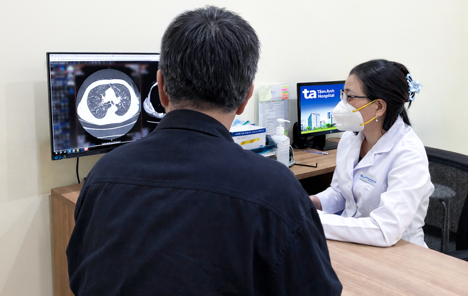 Bác sĩ Hà giải thích hình ảnh chụp CT phổi cho ông Tiến. Ảnh: Bệnh viện Đa khoa Tâm Anh
