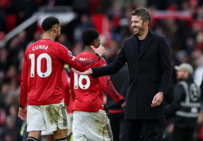 HLV Michael Carrick chia vui với Matheus Cunha sau trận Man Utd thắng Man City 2-0 ở vòng 22 Ngoại hạng Anh trên sân Old Trafford, Manchester, Anh hôm 17/1/2026. Ảnh: AFP