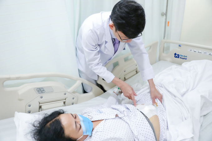 Bác sĩ Tấn khám cho chị Thuận trước khi xuất viện. Ảnh: Bệnh viện Đa khoa Tâm Anh