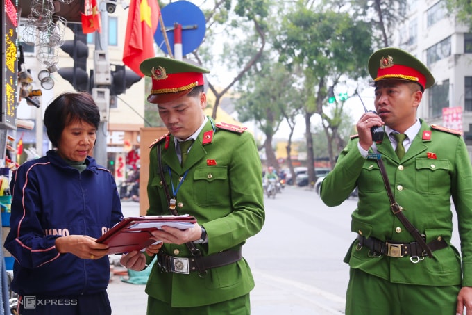Công an phường Ô Chợ Dừa, Hà Nội, kiểm tra một hộ kinh doanh trên phố An Trạch. Ảnh: Phạm Dự