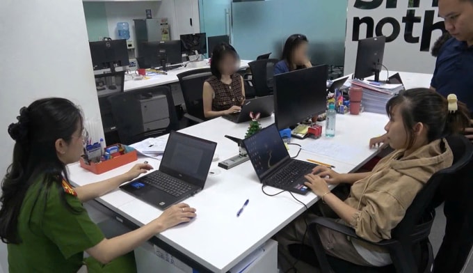 Cảnh sát cho Nguyễn Lương Mai Thy (áo vàng, bên phải) tại công ty thực nghiệm hiện trường. Ảnh: Công an TP HCM