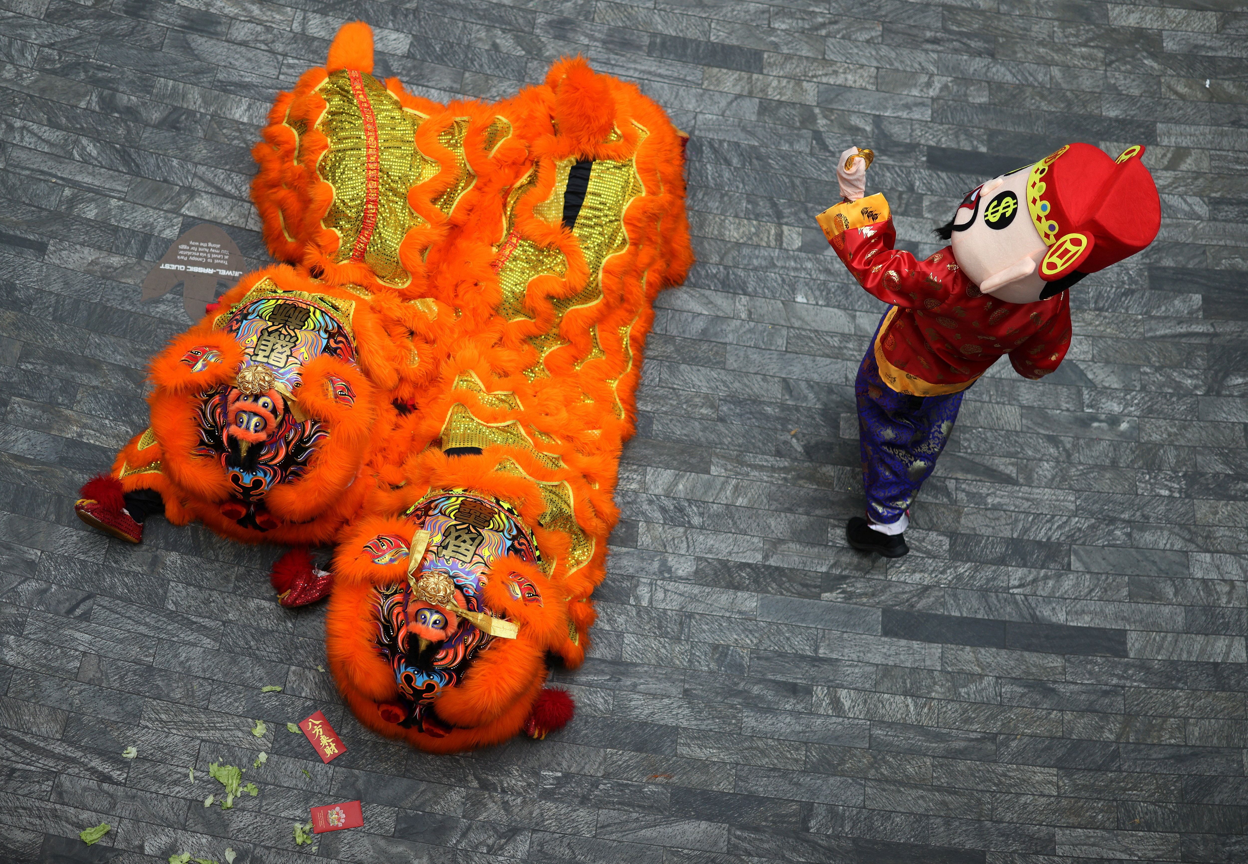 Một nghệ sỹ hóa trang thành thần Tài chuẩn bị ném 