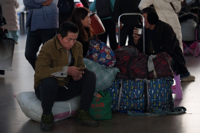 Hành khách ngồi chờ ở ga tàu Bắc Kinh, Trung Quốc hôm 10/2. Ảnh: AP