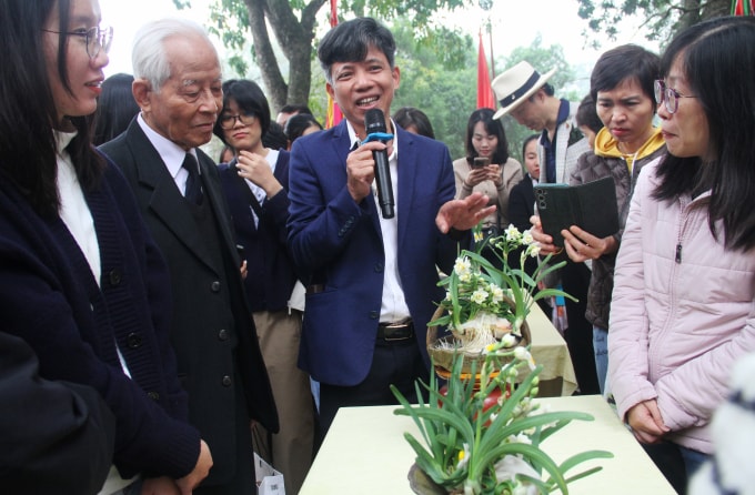 Anh Nguyễn Phúc Bích, 49 tuổi (cầm mic) ra mắt giới yêu hoa thủy tiên Hà Nội những bát hoa được trồng từ chính củ Việt, cuối tháng 1/2026. Ảnh: Phan Dương