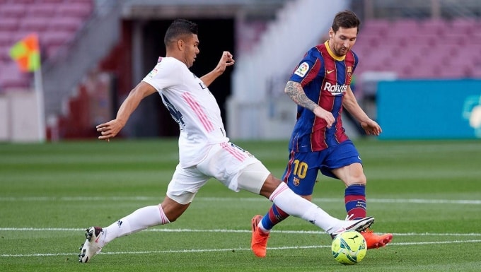 Casemiro (trái) đối đầu Messi trong trận Barca - Real mùa 2020-2021. Ảnh: FCB