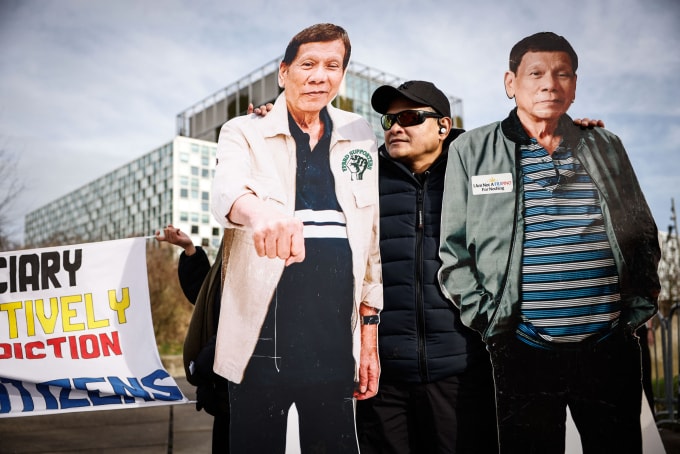 Người ủng hộ đứng giữa hai standee hình ông Duterte bên ngoài trụ sở Tòa Hình sự Quốc tế ở The Hague, Hà Lan ngày 23/2. Ảnh: AFP