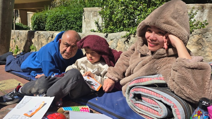 Gia đình chị Kim nằm ngoài đường, cạnh hầm trú ẩn để chui vào khi có cảnh báo, hôm 1/3. Ảnh: Gia đình cung cấp