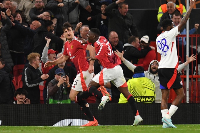 Maguire chạy ra cột cờ góc để mừng sau khi đánh đầu ghi bàn nâng tỷ số lên 5-4 cho Man Utd trong trận thắng Lyon ở lượt về tứ kết Europa League trên sân Old Trafford ngày 17/4/2025. Ảnh: AFP