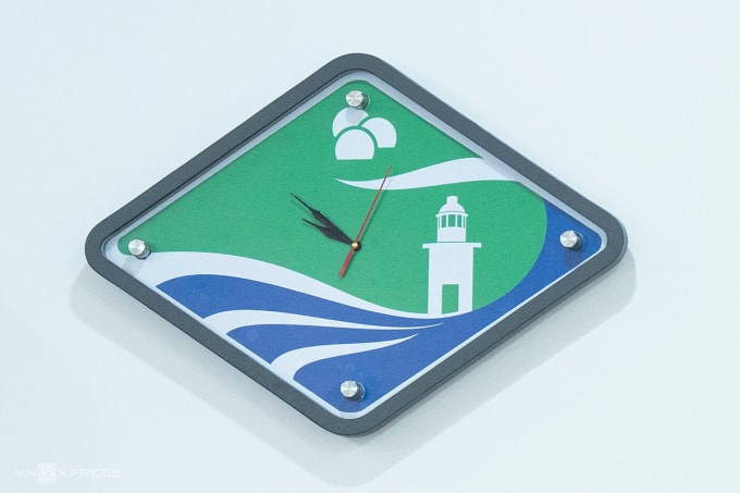 Logo biểu trưng của phường Sơn Trà với rừng, biển, ngọn hải đăng, trạm radar đã được ứng dụng vào nhiều vật dụng, trong đó có chiếc đồng hồ treo tại hội trường UBND phường. Ảnh: Nguyễn Đông