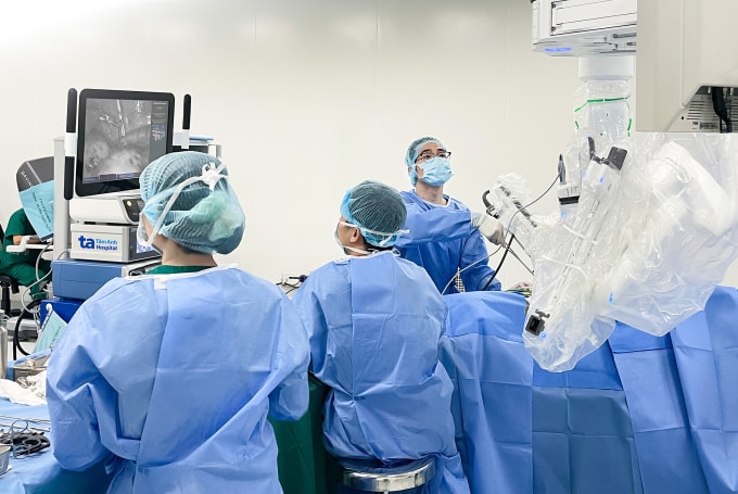 Phó giáo sư Vĩnh (ngoài cùng bên trái) điều khiển robot Da Vinci Xi cắt bỏ khối u cho ông Hiếu. Ảnh: Bệnh viện Đa khoa Tâm Anh