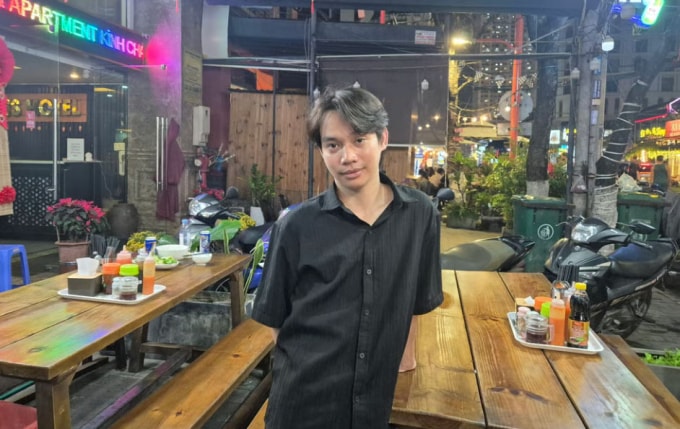 Văn Chín chụp ảnh tại quán nơi đang làm việc tại Đà Nẵng. Ảnh: SCMP