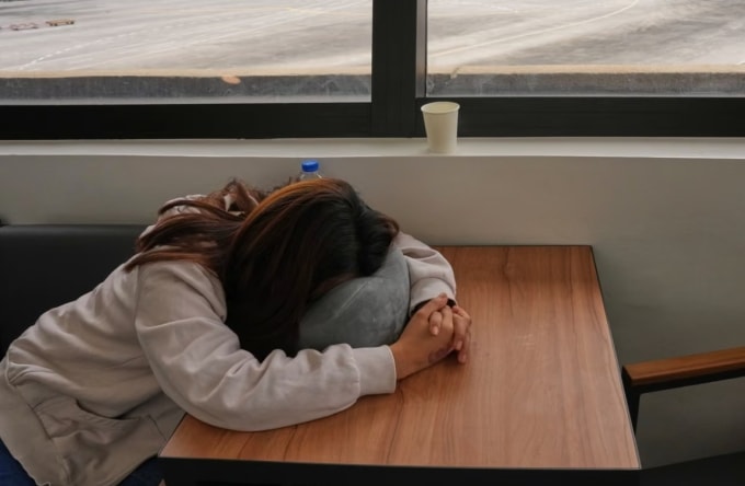 Một nữ lao động ngủ gật trong khi chờ đợi thông tin cập nhật về chuyến bay bị hủy đến Trung Đông tại sân bay quốc tế Manila. Ảnh: Aaron Favila/AP