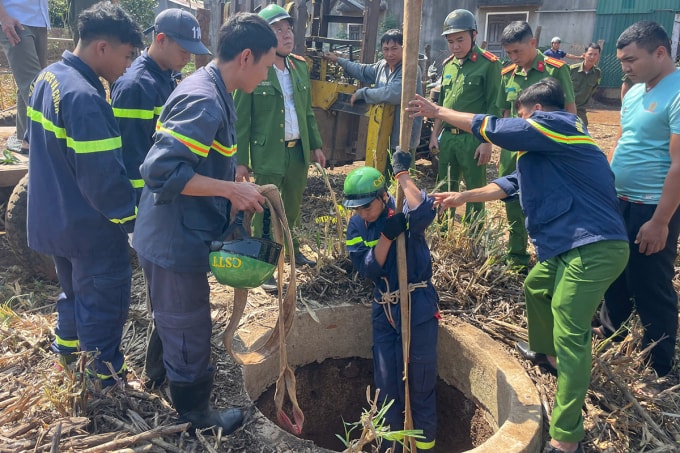 Cảnh sát xuống giếng cứu đứa bé. Ảnh: Ngọc Oanh