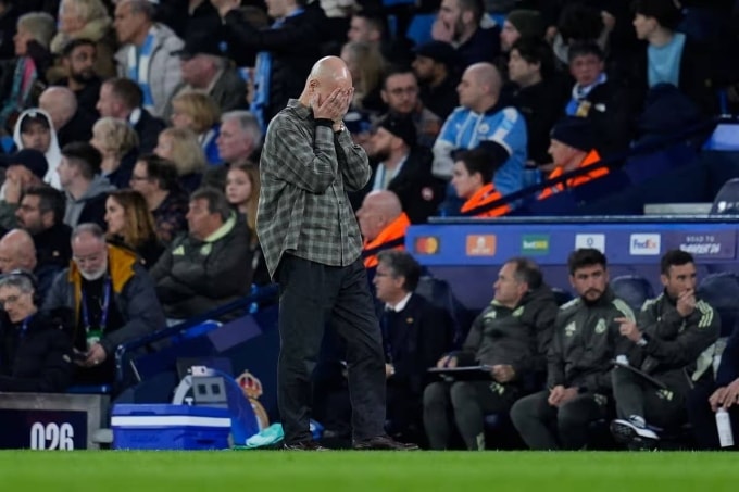 Guardiola ôm mặt thất vọng trong trận Man City 1-2 Real ở lượt về vòng 1/8 Champions League tối 17/3. Ảnh: EP