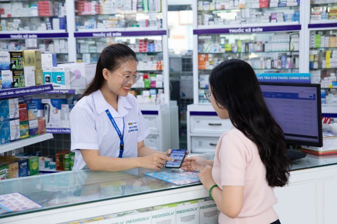 Nhân viện tại một hiệu thuốc Long Châu giới thiệu với khách hàng ứng dụng Ví khỏe nhà ta. Ảnh: Long Châu