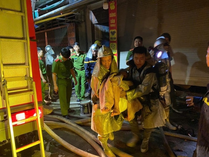 Cảnh sát phòng cháy đưa người bị kẹt ra ngoài. Ảnh: Thanh Oai