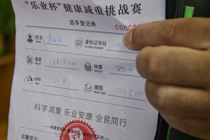 Phiếu tham gia chương trình đổi mỡ lấy thịt bò ghi lại họ tên, căn cước công dân, chiều cao, cân nặng, chỉ số BMI và vòng bụng của người tham gia. Ảnh: AFP
